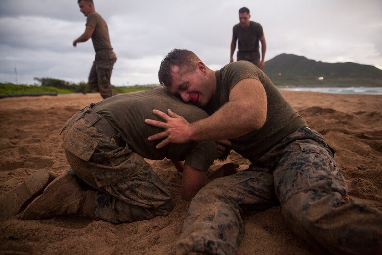 Cpl. David Waisner, a combat engineer with Combat Assault Company (CAC), 3rd Marine Regiment, grapples with another Marine for the 74th anniversary of the Battle of Tarawa, Fort Hase Beach, Marine Corps Base Hawaii (MCBH), Nov. 20, 2017. CAC celebrated the anniversary with a motivational run and beach grappling to promote comradery among the Marines, while understanding the sacrifices at Tarawa. MCBH, along with its tenant units, strives to promote resiliency in remembering the past battles won and to instill in the newest generation what it means to be U.S. Marine.