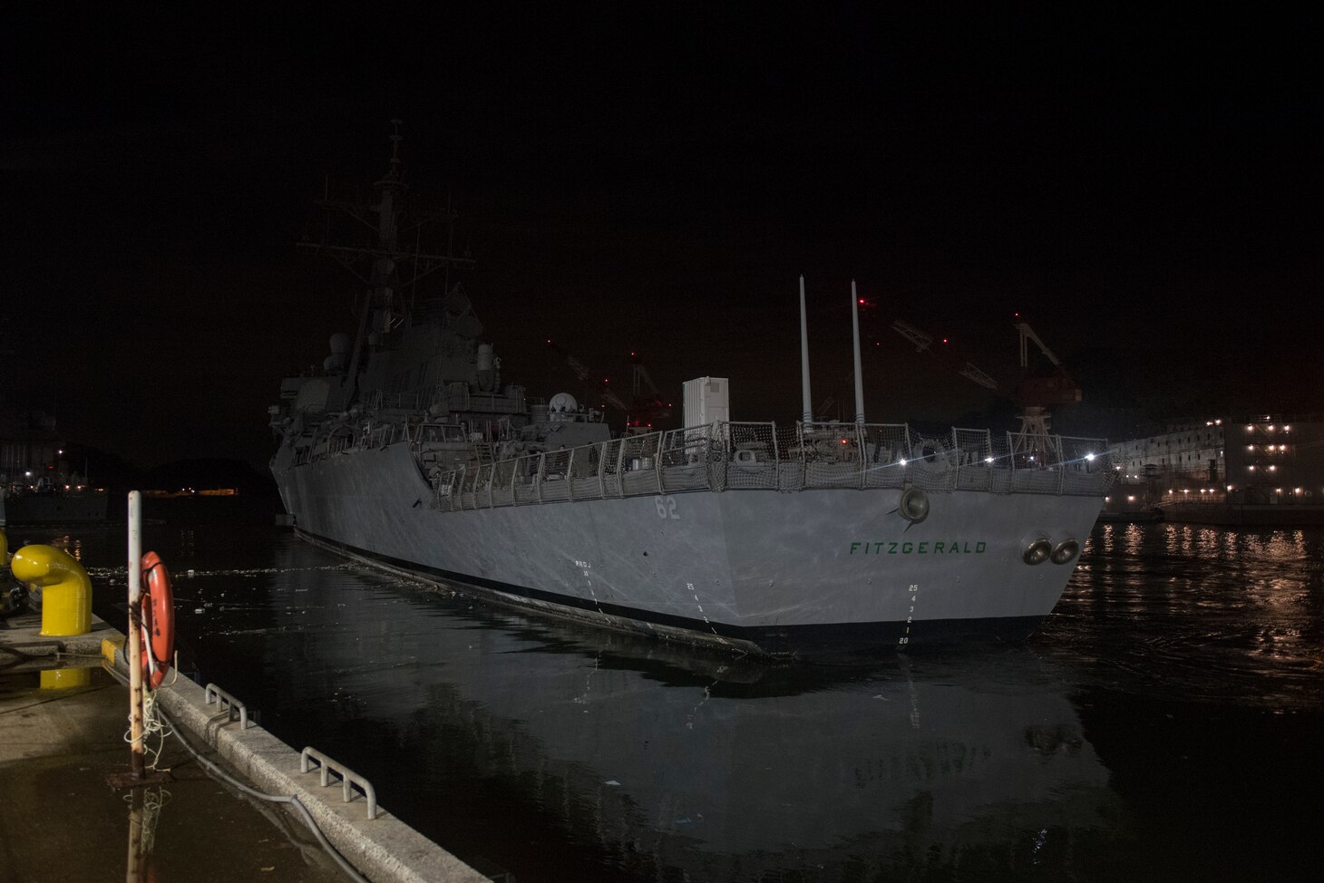 The Arleigh Burke-class guided missile destroyer USS Fitzgerald (DDG 62) is towed away from the pier at Fleet Activities (FLEACT) Yokosuka, Nov. 24, to meet heavy lift transport vessel Transshelf. Transshelf will transport Fitzgerald to Pascagoula, Mississippi for repairs.