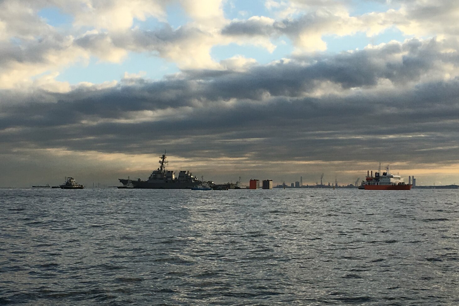 The Arleigh Burke-class guided-missile destroyer USS Fitzgerald (DDG 62) stands by before it is loaded onto the heavy lift transport vessel MV Transshelf. Transshelf will transport Fitzgerald to Pascagoula, Mississippi to complete repairs.