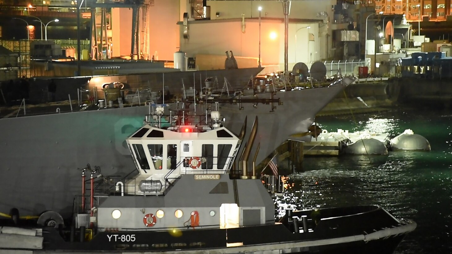 The Arleigh Burke-class guided-missile destroyer USS Fitzgerald (DDG 62) is towed away from the pier at Fleet Activities (FLEACT) Yokosuka, Nov. 24, to meet heavy lift transport vessel MV Transshelf. Transshelf will transport Fitzgerald to Pascagoula, Mississippi for repairs.