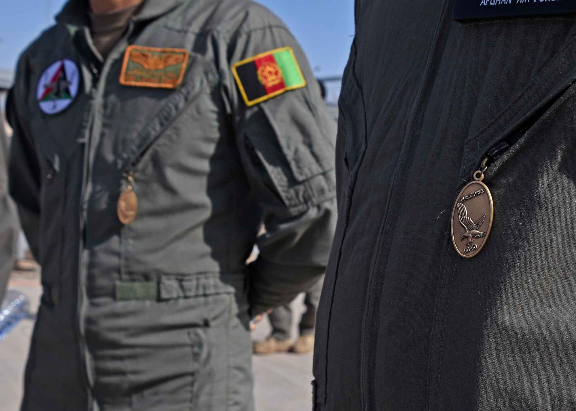 Afghan Air Force pilots wear Black Hawk pendants given by instructors signifying their completion of UH-60 Black Hawk training at Kandahar Airfield, Afghanistan, Nov. 20, 2017. The pilots are the first six to become AAF UH-60 pilots. The pilots have prior experience in the Mi-17 Hip. The transition of airframe for the AAF pilots will provide firepower and mobility, significant offensive factors enabling the Afghan National Defense and Security Forces to break the stalemate with insurgents. (U.S. Air Force photo by Tech. Sgt. Veronica Pierce)