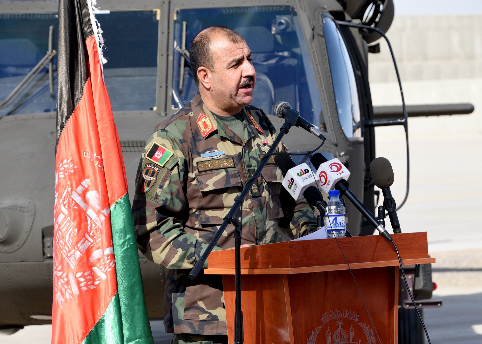 Afghan Air Force Maj. Gen. Abdul Raziq Sherzai, Kandahar Air Wing commander, addresses the first AAF UH-60 Black Hawk pilots during an Aircraft Qualification Training graduation ceremony at Kandahar Airfield, Afghanistan, Nov. 20, 2017. The six pilots are the first to transition from the Mi-17 Hip, as part of a lager modernization program. The AAF is expecting to have four qualified crews by fighting season 2018, and 32 crews by fighting season 2019.  (U.S. Air Force photo by Tech. Sgt. Veronica Pierce)