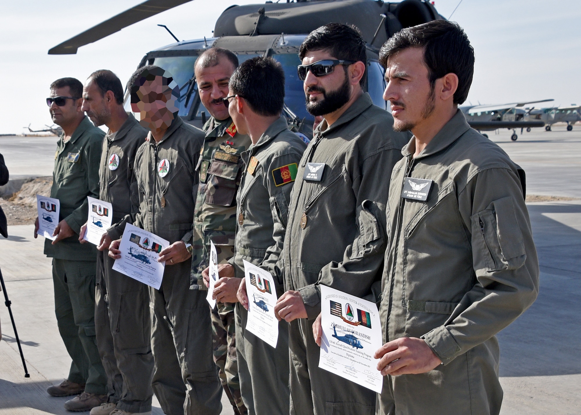 Afghan Air Force pilots display their certificates after a UH-60 Black Hawk Aircraft Qualification Training graduation ceremony at Kandahar Airfield, Afghanistan, Nov. 20, 2017. The six pilots are the first AAF Black Hawk pilots, is part of a larger modernization program. The Afghan Air Force will more than double their fleet of aircraft over the next seven years. Plans include the introduction of AC-208 attack aircraft and UH-60 Black Hawk assault helicopters, and additional A-29 attack aircraft and MD-530 attack helicopters to the force. (U.S. Air Force photo by Tech. Sgt. Veronica Pierce)