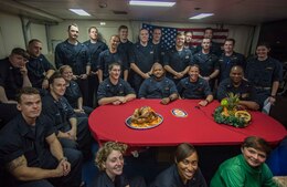 Sailors pose for a photo before speaking to the Commander-in-Chief, President Donald Trump, aboard the guided-missile cruiser USS Monterey (CG 61).