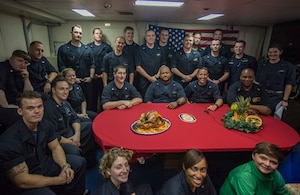 Sailors pose for a photo before speaking to the Commander-in-Chief, President Donald Trump, aboard the guided-missile cruiser USS Monterey (CG 61).