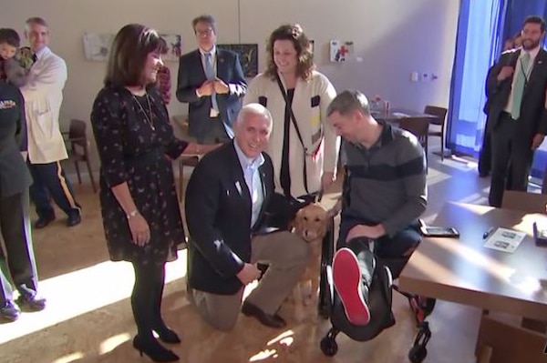 Vice President Mike Pence and Second Lady Karen Pence stand next to a man in a wheelchair.