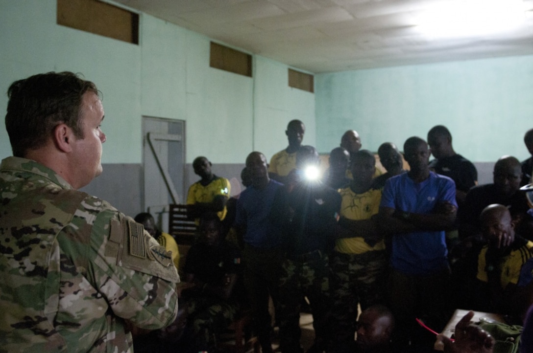 Army Staff Sgt. Joshua Crenshaw, left, an explosive ordnance disposal technician from the 764th Ordnance Company from Fort Carson, Colo., instructs troops from the Cameroonian armed forces.