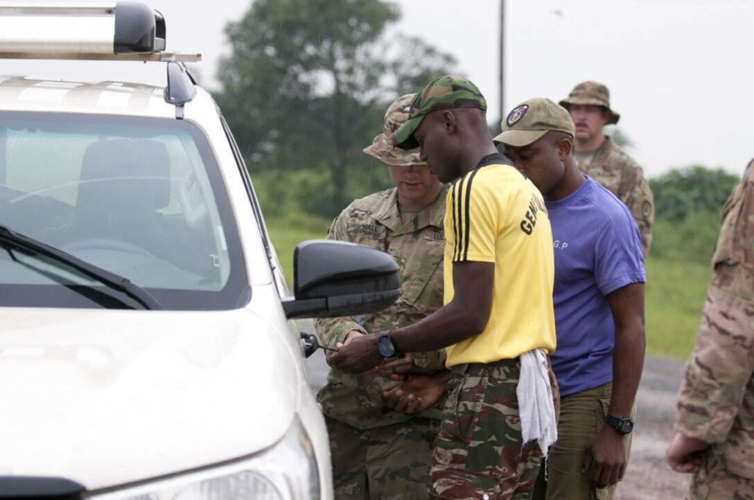 Army 1st Lt. Jacob Schall, left, a platoon leader for the 764th Ordnance Company from Fort Carson, Colo., instructs Cameroonian troops.