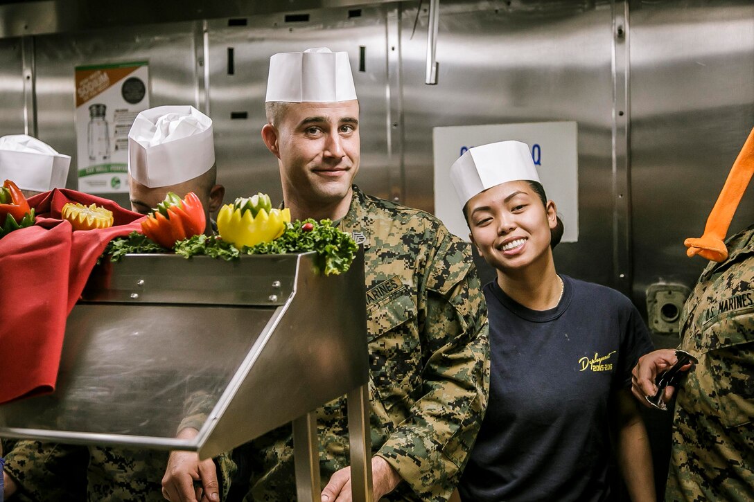 U.S. Marines and Sailors with Fox Company, Battalion Landing Team, 2nd Battalion, 6th Marine Regiment, 26th Marine Expeditionary Unit (MEU) and Sailors assigned to the dock landing ship USS Oak Hill (LSD 51), serve a Thanksgiving meal to personnel aboard the Oak Hill, during Combined Composite Training Unit Exercise (COMPTUEX). Combined COMPTUEX serves as the capstone event for the Amphibious Ready Group-MEU team prior to a deployment, fully integrating the ARG-MEU team as an amphibious force and testing their ability to execute missions across a range of military operations. (U.S. Marine Corps photo by Staff Sgt. Dengrier M. Baez)