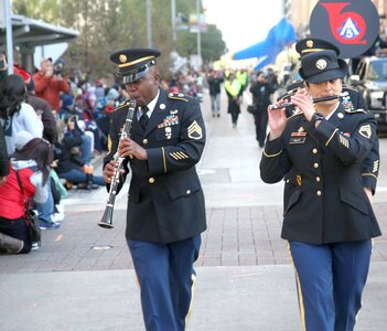 Members of the 323rd Army Band “Fort Sam's Own” entertain the crowd Thanksgiving Day morning Nov. 23 while  marching in the 68th Annual Houston Thanksgiving Day Parade.