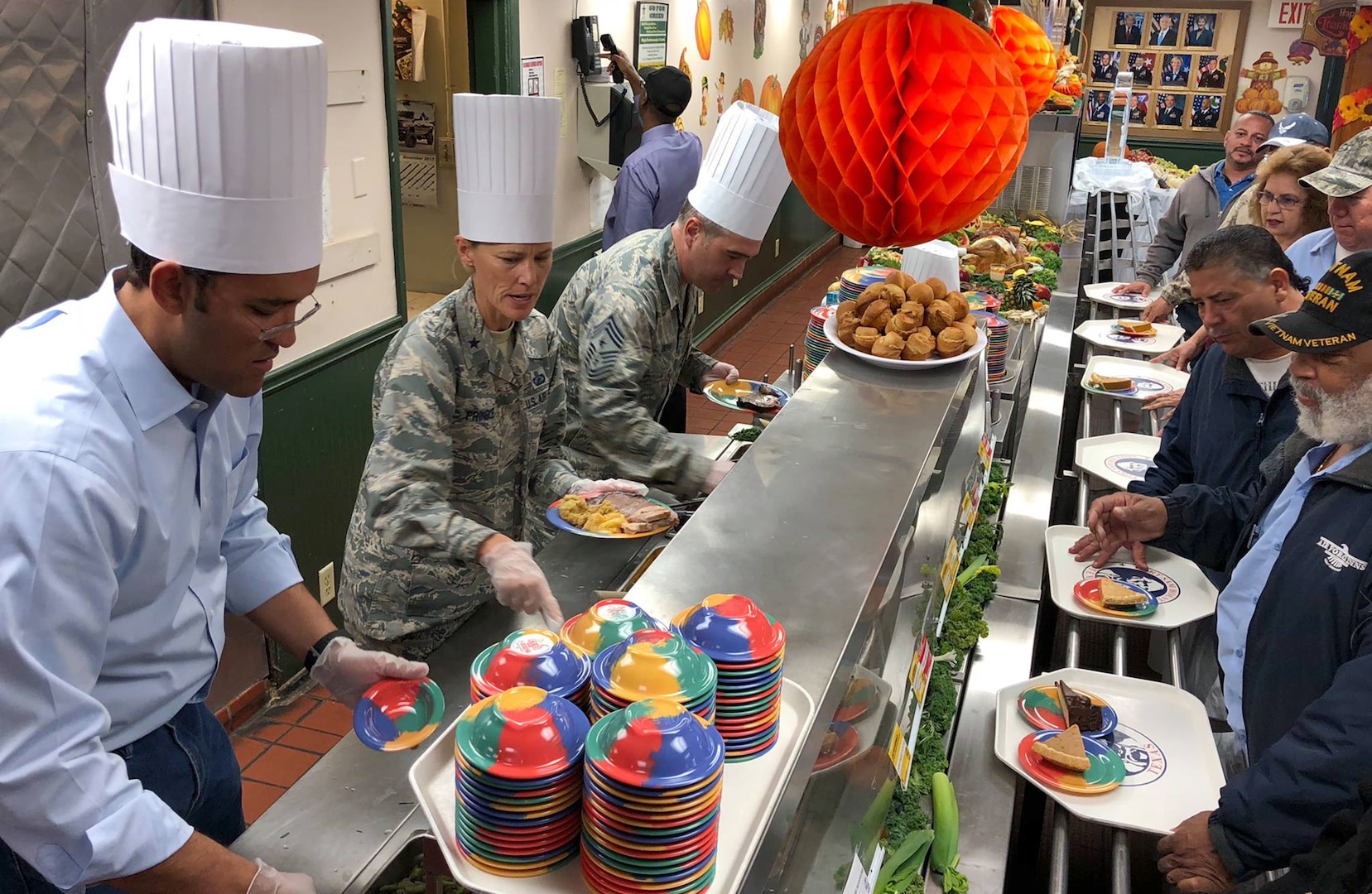 (From left) U.S. Representative Will Hurd, Brig. Gen. Heather Pringle, the commander of the 502nd Air Base Wing and Joint Base San Antonio, and Chief Master Sgt. Kristopher Berg, the 502nd Air Base Wing and JBSA senior enlisted advisor, serve Thanksgiving dinner to workers and service members at JBSA-Camp Bullis' main dining facility Nov. 22.