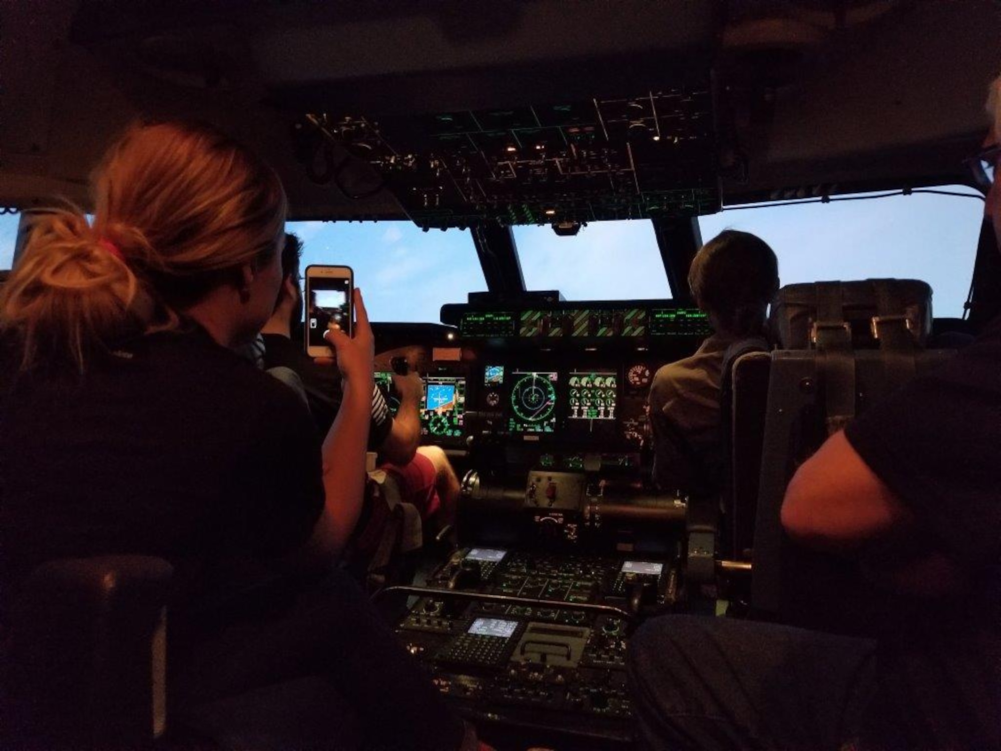 Civic Leader, Britni Ridolfi, Captures her experience on her cell phone of flying in a C-5M Super Galaxy Simulator, Nov. 18, 2017, during a 433rd Operations’ Group on Joint Base San Antonio, Texas. (U.S. Air Force photo by Minnie Jones
