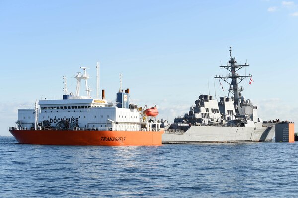 The Arleigh Burke-class guided-missile destroyer USS Fitzgerald (DDG 62) is loaded onto heavy lift transport MV Transshelf. Transshelf will transport Fitzgerald to Pascagoula, Mississippi to complete repairs.