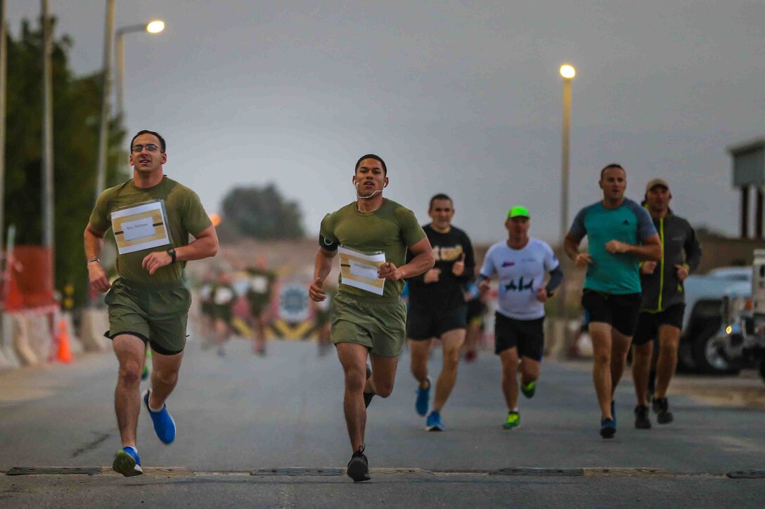 U.S. Marines Chief Warrant Officer 2 Jonathan D. Eaton (left), mobility officer, Command Element, Special Purpose Marine Air-Ground Task Force – Crisis Response – Central Command and Sgt. Emmanuel Gonzalez (right), embarkation chief, CE, SPMAGTF-CR-CC ran the 5k Turkey Trot while deployed to the Middle East Nov. 23, 2017. Thirty-two Marines and Sailors deployed with SPMAGTF-CR-CC partnered with a non-profit organization to sponsor children with spinal bifida and cerebral palsy to raise awareness about the two conditions.