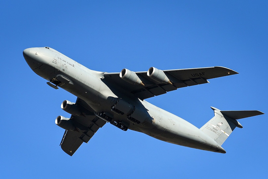 A military aircraft flies away from Travis Air Force Base.