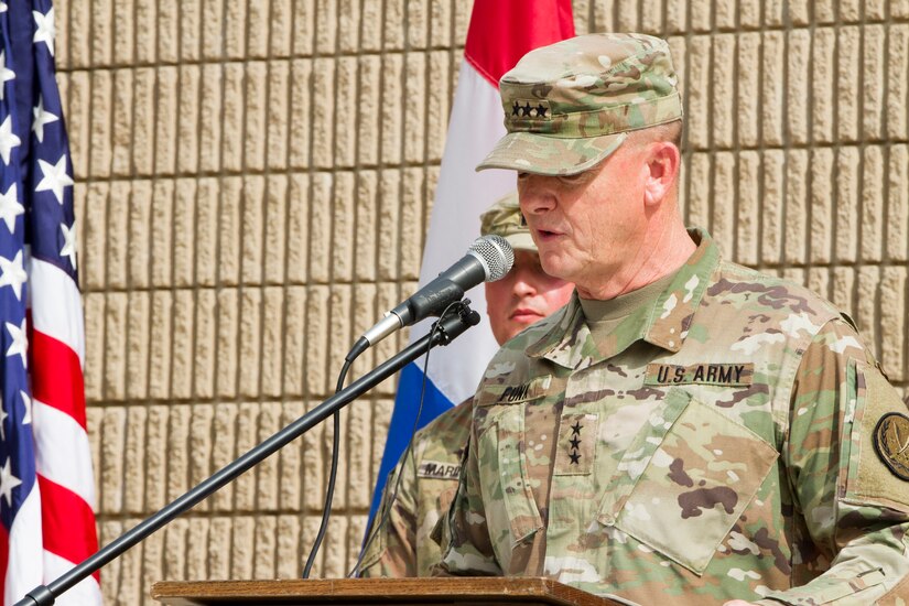 Army General gives a speech at a podium.