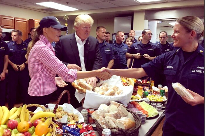 First Lady Melania Trump shakes hands with a Coast Guard member during a Thanksgiving meal visit.