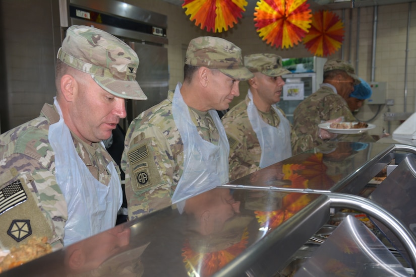 Officers serving the Thanksgiving meal to Soldiers.
