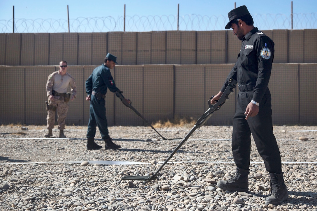 A U.S. Marine observes as Afghan national policemen participate in lane training.
