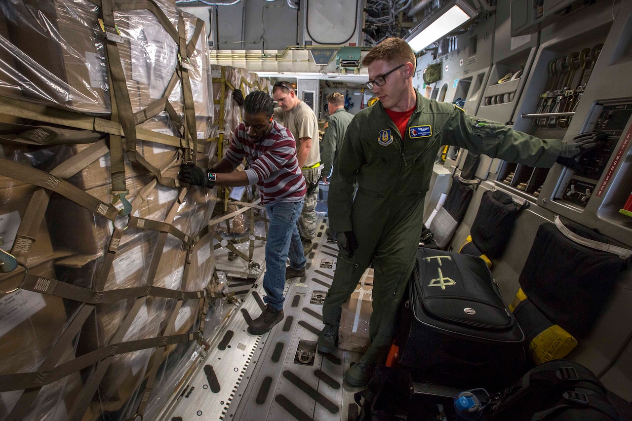Air Force Staff Sgt. Adam D. Van Horn, C-17 Globemaster III loadmaster assigned to the 514th Air Mobility Wing's 732nd Airlift Squadron, locks a cargo pallet in place at Joint Base Charleston, S.C., Nov. 17, 2017. Air Force photo by Master Sgt. Mark C. Olsen