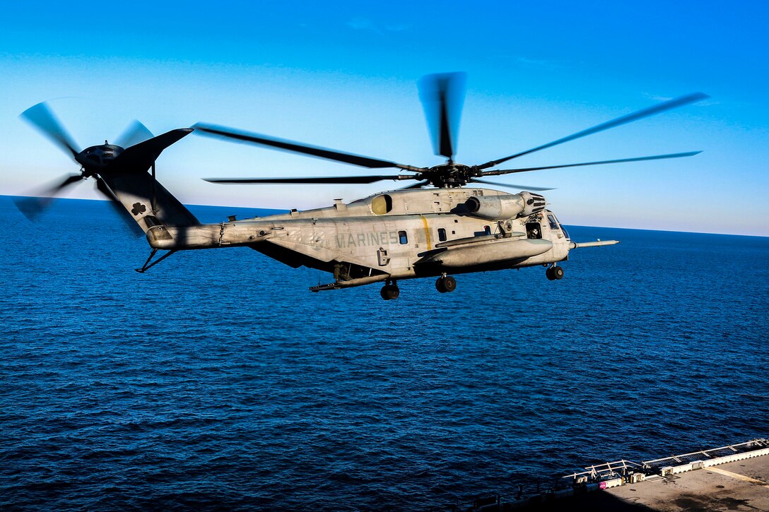 A Marine Corps CH-53E Super Stallion helicopter prepares to land on the amphibious assault ship USS Iwo Jima.