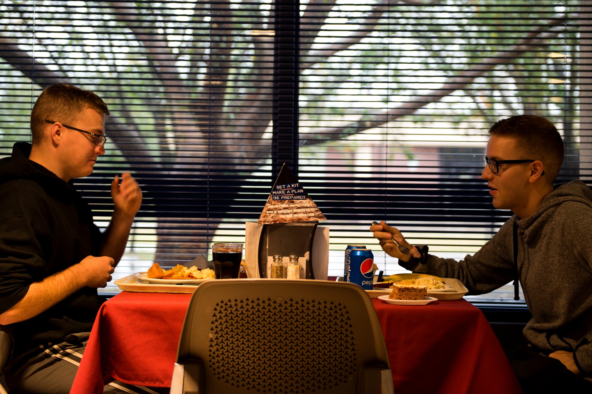 Airman Brayden Olson, left, and Airman 1st Class Dalton Murphy, both 723d Aircraft Maintenance Squadron crew chiefs, eat together on Thanksgiving Day in the Georgia Pines Dining Facility, Nov. 23, 2017, at Moody Air Force Base, Ga. The Thanksgiving Day meal was an opportunity for Airmen, retirees, dependents and leadership to enjoy a traditional Thanksgiving meal. (U.S. Air Force photo by Airman 1st Class Erick Requadt)