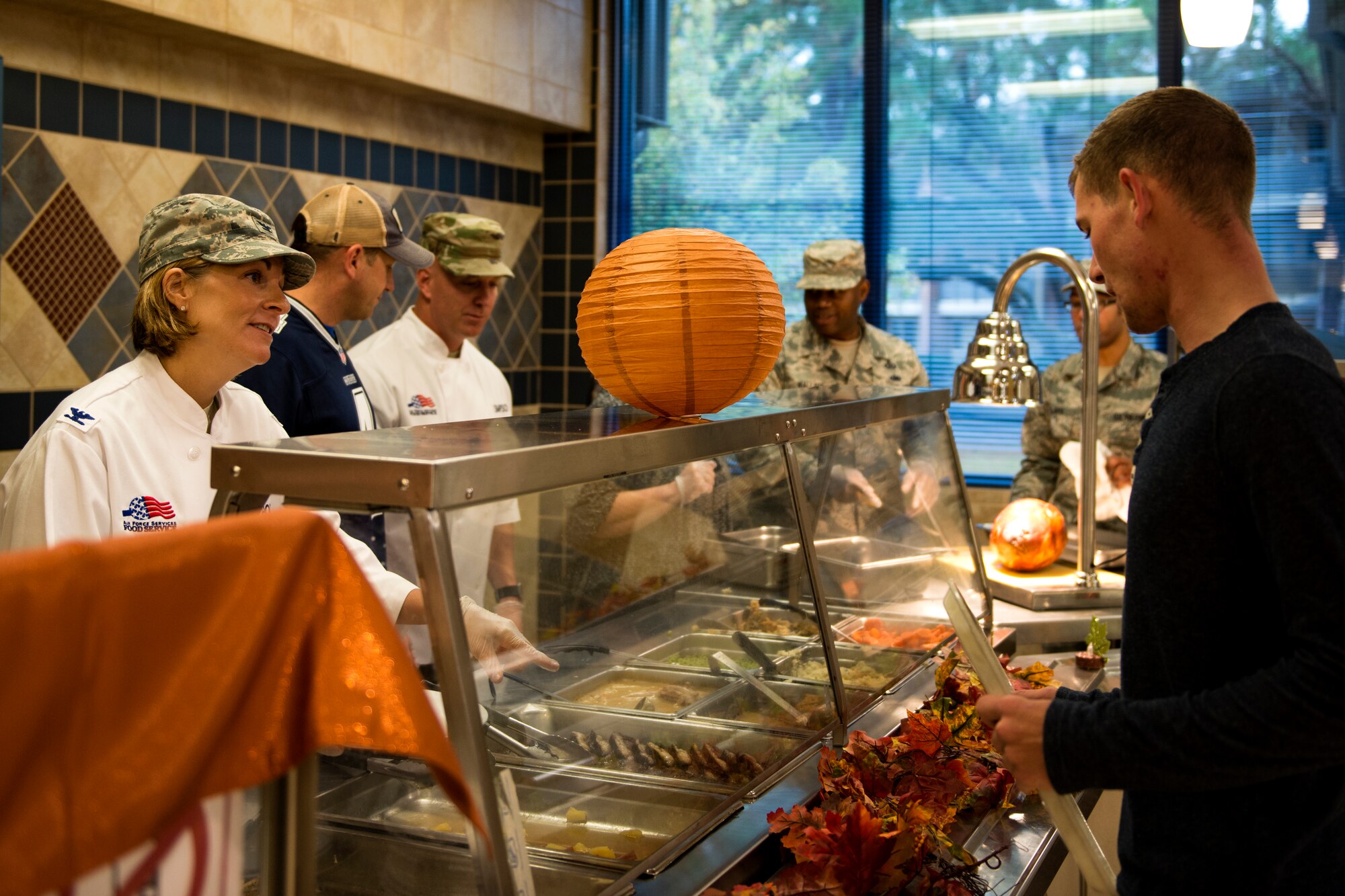 Col. Jennifer Short, 23d Wing commander, left, serves food to Airman 1st Class Tristan Batten, 23d Civil Engineer Squadron water and fuels system maintenance technician, on Thanksgiving Day in the Georgia Pines Dining Facility, Nov. 23, 2017, at Moody Air Force Base, Ga. The Thanksgiving Day meal was an opportunity for Airmen, retirees, dependents and leadership to enjoy a traditional Thanksgiving meal. (U.S. Air Force photo by Airman 1st Class Erick Requadt)