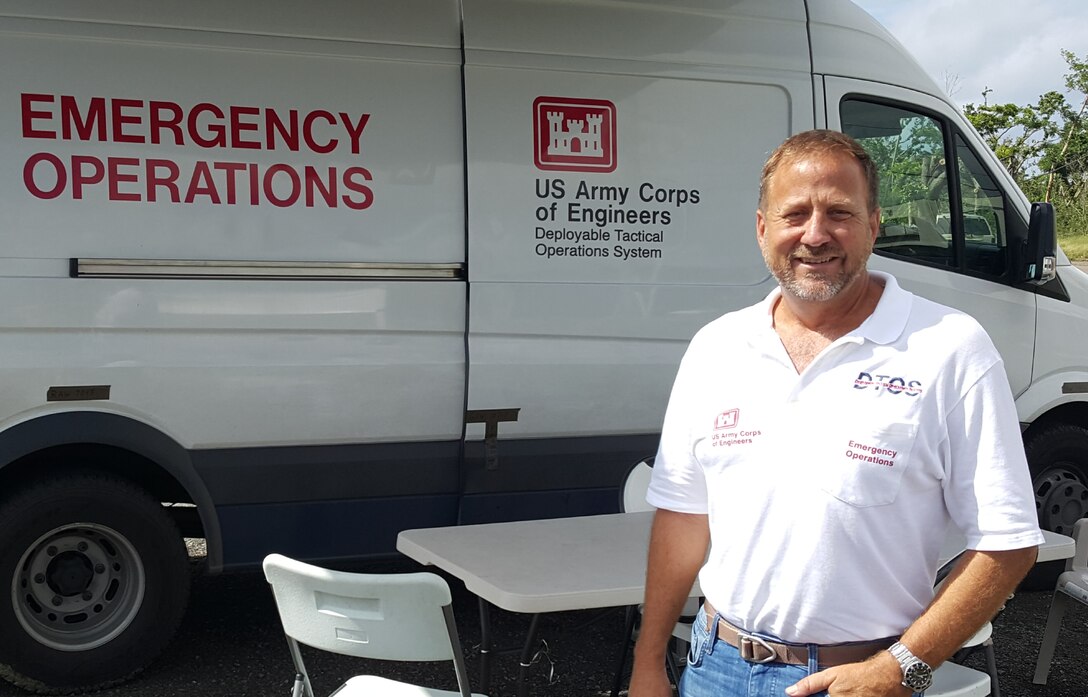 Kenneth “Sam” Hill poses in front of a Deployable Tactical Operations System while on deployment in St. Croix, U.S. Virgin Islands. While driving one night on a remote country road, Hill and a St. Louis District employee rendered aid after happening upon a head-on collision accident.