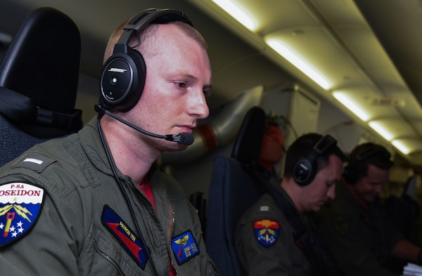 A Sailor coordinates tactics on a P-8a Poseidon aircraft.