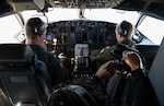 Pilots fly a P-8a Poseidon aircraft.