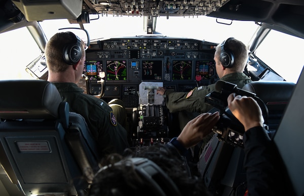 Pilots fly a P-8a Poseidon aircraft.