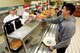 Master Sgt. Joshua McLaughlin, 4th Force Support Squadron first sergeant, serves a meal to Airman Christian Ramirez, F-15E Strike Eagle student crew chief, at the 4th FSS dining facility Nov. 23, 2017, at Seymour Johnson Air Force Base, North Carolina. Base leaders helped serve more than 150 meals to dining facility guests on Thanksgiving Day. (U.S. Air Force photo by Airman 1st Class Kenneth Boyton)