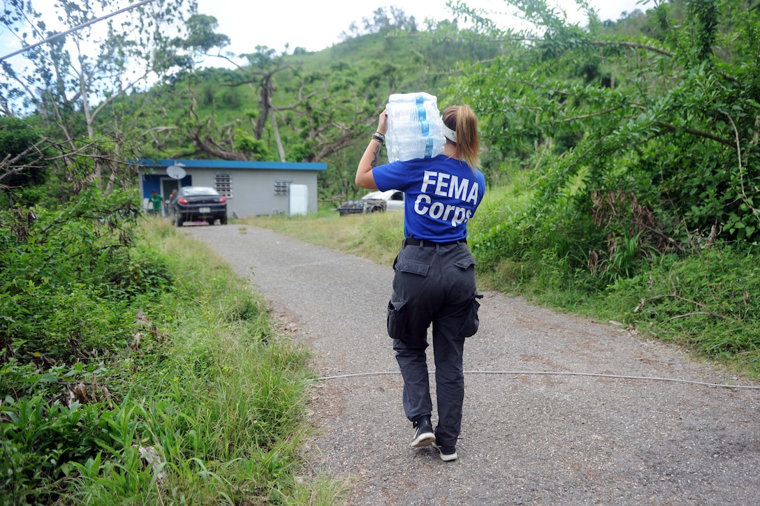 FEMA worker delivers water.