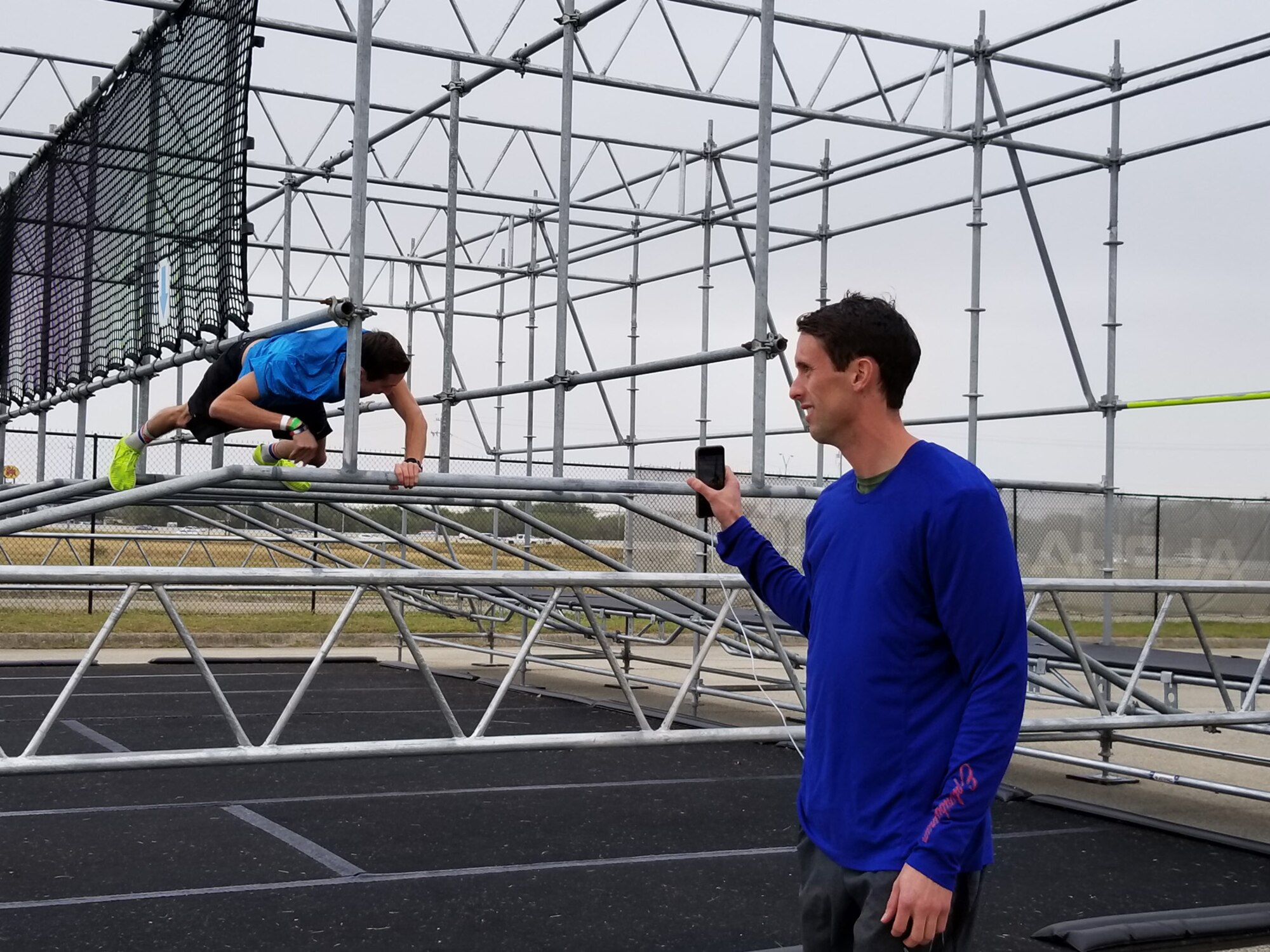 .S. Air Force Capt. Rob Simmons tackles the Gut Buster obstacle on the Alpha Warrior Battle Rig at Retama Park in Selma, Texas, as his identical twin brother, Capt. Cale Simmons, shoots video. Cale placed second in the men's division in the Air Force Alpha Warrior Final Battle on Nov. 11, 2017. (U.S. Air Force photo by Carole Chiles Fuller)