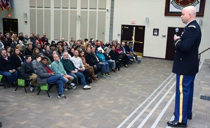 Lt. Col. Sean C, Lester, commander of the 264th Medical Battalion, Army Medical Department Center & School at Joint Base San Antonio-Fort Sam Houston briefs families before they meet their Soldiers Nov. 23.