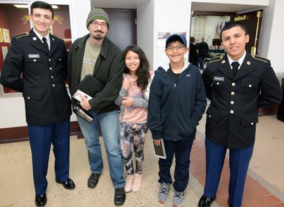 William Ryan, with his children Emilia and Simon, hosting Pvt. Nathan Elsnew from Orange, Calif., and Pvt. Mike Granados from Fort Wayne, Ind.