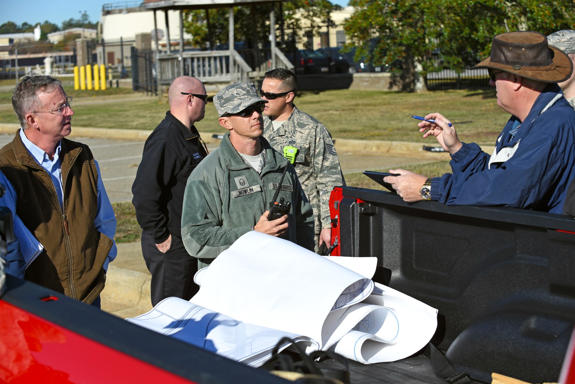 Fuel spill major accident response exercise participants discuss the simulated scenario at Shaw Air Force Base, South Carolina, Nov. 17, 2017.