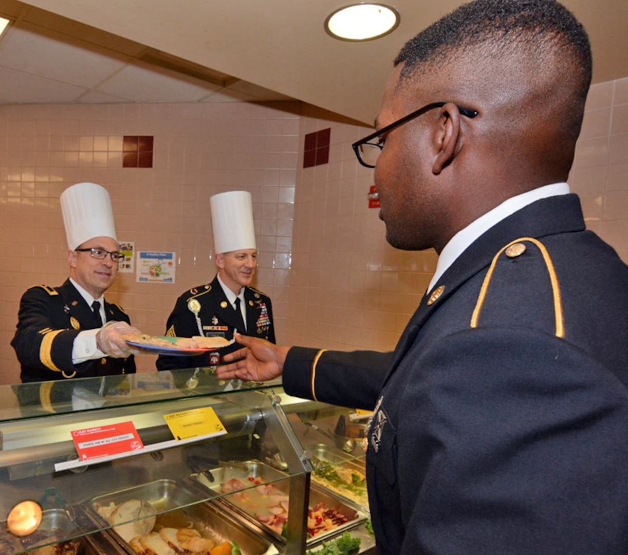 Maj. Gen. Brian C. Lein, Commanding General, Army Medical Department Center & School at Joint Base San Antonio-Fort Sam Houston, AMEDDC&S Command Sgt. Maj. Buck O'Neal and other leaders serve Thanksgiving dinner to Soldiers at the Rocco Dining Facility at JBSA-Fort Sam Houston Nov. 23.