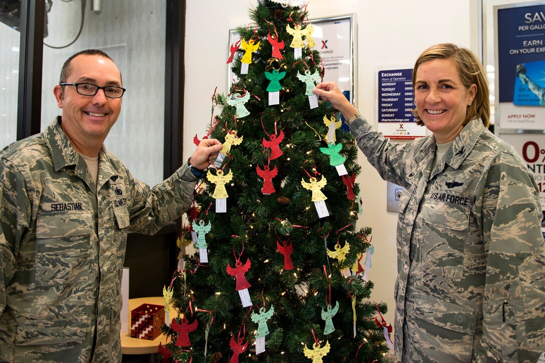 Chief Master Sgt. Jarrod Sebastian, left, 23d Wing command chief, and Col. Jennifer Short, 23d Wing commander, pose for a photo, Nov. 27, 2017, at Moody Air Force Base, Ga. Each year, community members pull ornaments from the trees located at the Base Exchange and the Freedom 1 Fitness Center with a child’s description and their desired gift, and purchase the gift to be given anonymously. (U.S. Air Force photo by Airman 1st Class Erick Requadt)