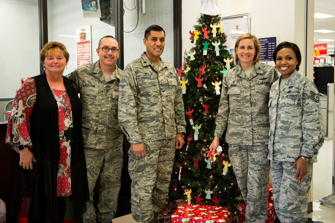 Members from Team Moody pose for a photo, Nov. 27, 2017, at Moody Air Force Base, Ga. Each year, community members pull ornaments from the trees located at the Base Exchange and the Freedom 1 Fitness Center with a child’s description and their desired gift, and purchase the gift to be given anonymously. (U.S. Air Force photo by Airman 1st Class Erick Requadt)