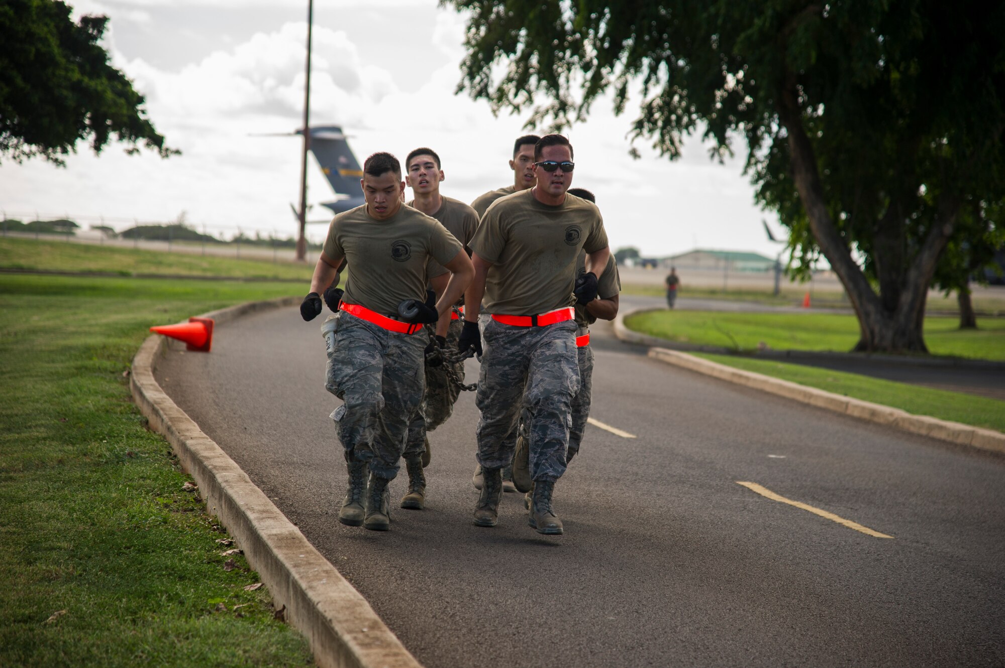 Members of the 48th Aerial Port Squadron participate in the run portion of the combat fitness challenge portion of the Hickam Port Dawg Challenge, at Joint Base Pearl Harbor-Hickam, Hawaii, Nov. 17, 2017.