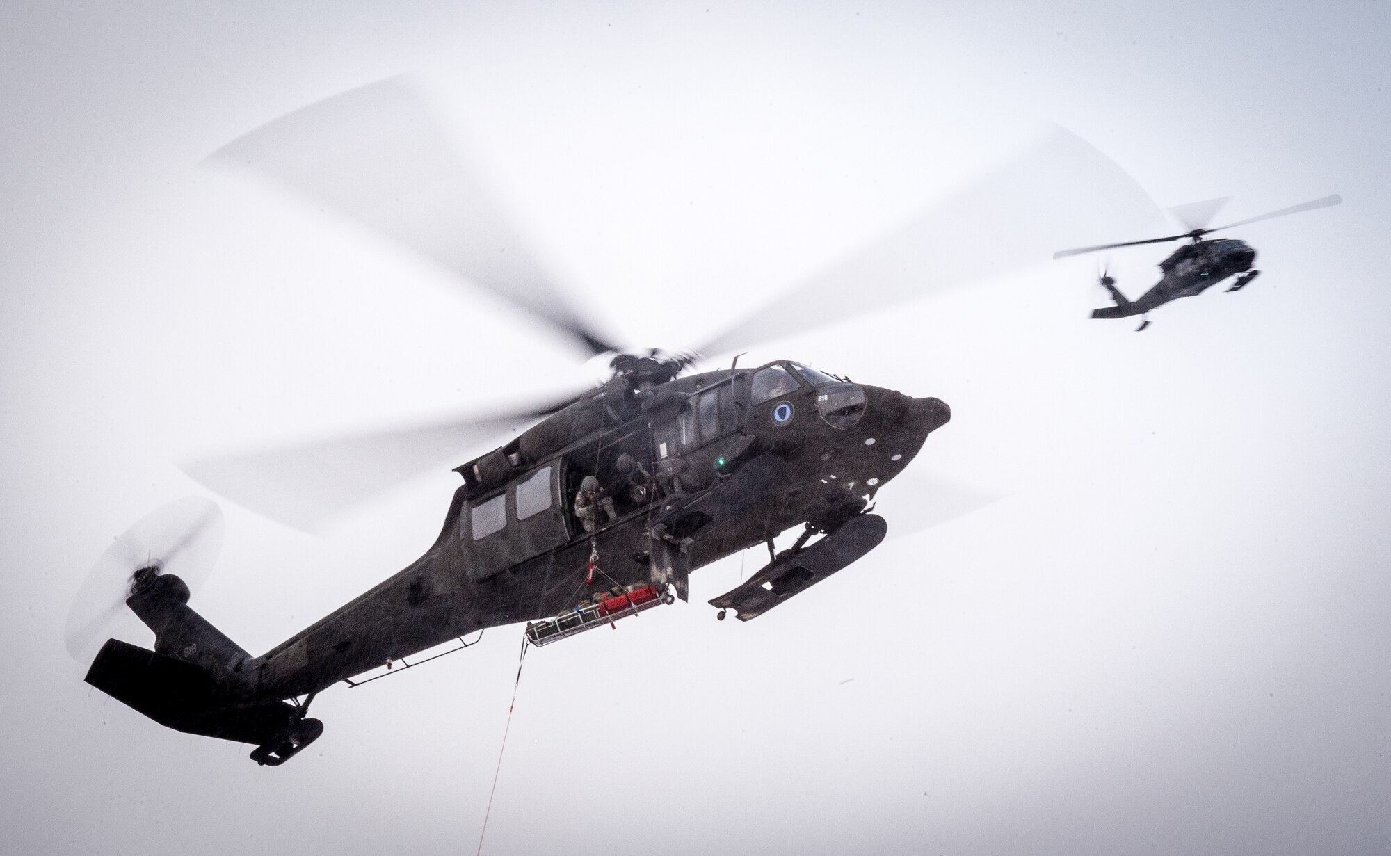 Alaska Air National Guardsmen assigned to the 212th Rescue Squadron lift a casualty into a UH-60 Black Hawk during a mass-casualty search-and-rescue training at Joint Base Elmendorf-Richardson, Alaska, Nov. 21, 2017. During the exercise, the rescue operators located, assessed, treated and evacuated numerous casualties while engaging and eliminating multiple attacks from opposition forces. In addition to training for combat search-and-rescue missions, the 212th Rescue Squadron also provides emergency rescue services for Alaska residents and visitors. (U.S. Air Force photo by Senior Airman Curt Beach)