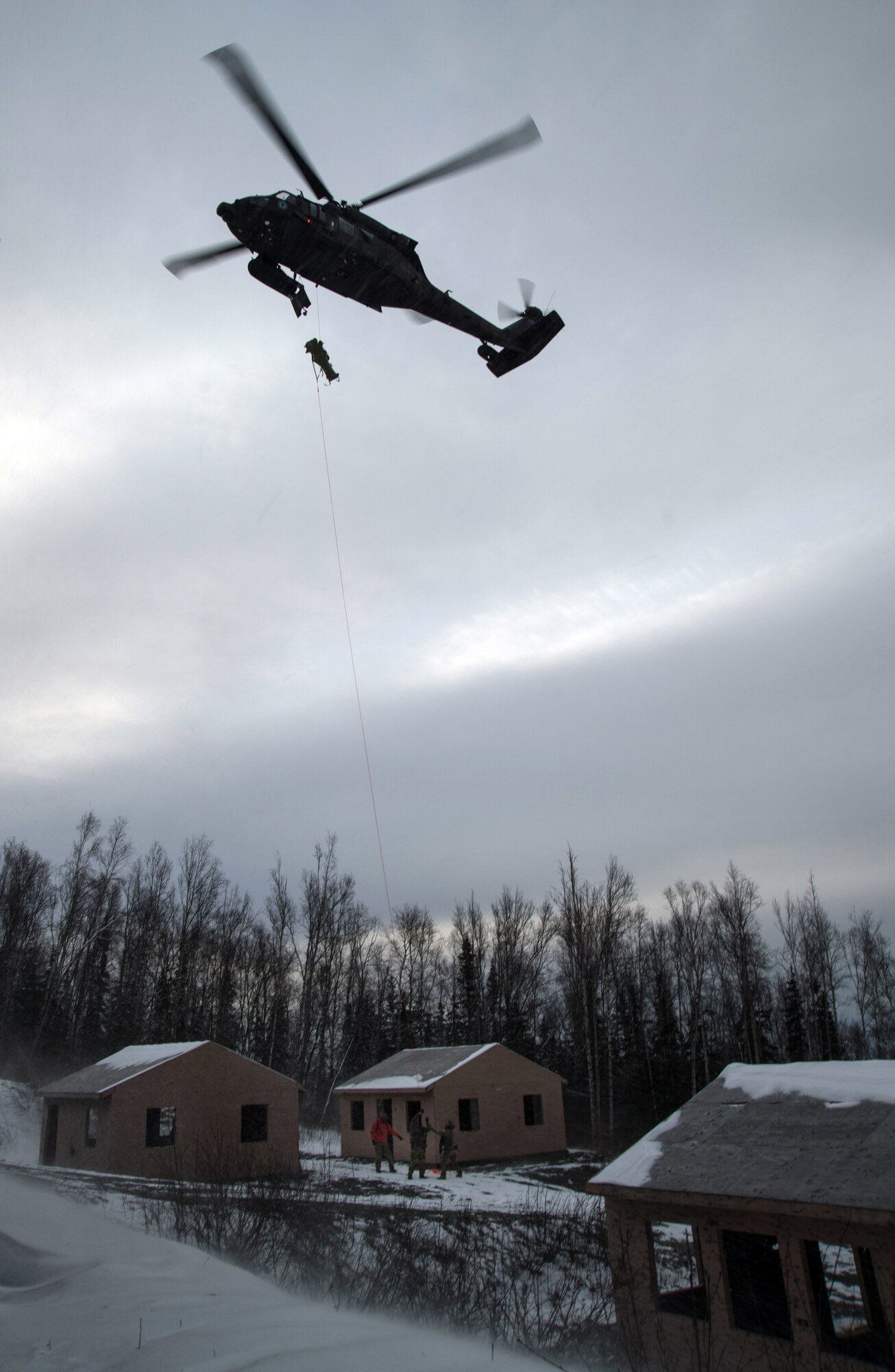 Alaska Air National Guardsmen assigned to the 212th Rescue Squadron evacuate a casualty into a UH-60 Black Hawk during a mass-casualty search-and-rescue training at Joint Base Elmendorf-Richardson, Alaska, Nov. 21, 2017. During the exercise, the rescue operators located, assessed, treated and evacuated numerous casualties while engaging and eliminating multiple attacks from opposition forces. In addition to training for combat search-and-rescue missions, the 212th Rescue Squadron also provides emergency rescue services for Alaska residents and visitors. (U.S. Air Force photo by Senior Airman Curt Beach)