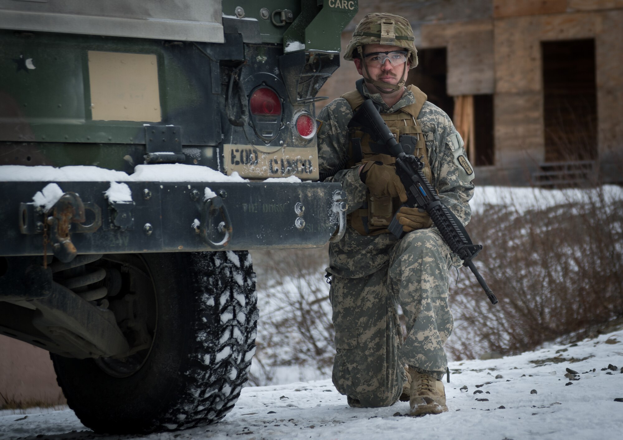 A Soldier assigned to the 716th Explosive Ordnance Disposal Company scans the area for threats after taking contact from opposition forces during a mass-casualty search-and-rescue training at Joint Base Elmendorf-Richardson, Alaska, Nov. 21, 2017. During the exercise, JBER Airmen and Soldiers located, assessed, treated and evacuated numerous casualties while engaging and eliminating multiple attacks from opposition forces. (U.S. Air Force photo by Senior Airman Curt Beach)