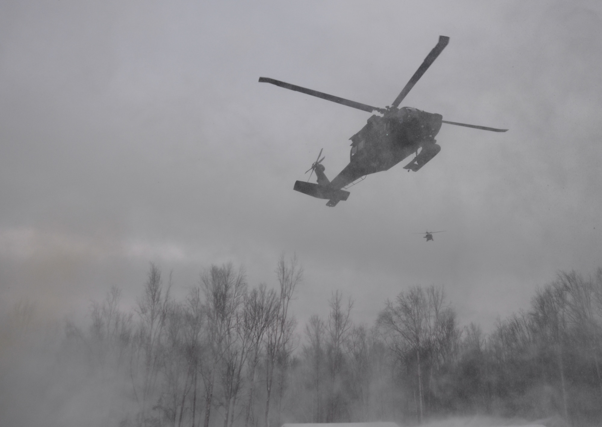 Alaska Army National Guard UH-60 Black Hawk helicopters arrive on scene during a mass-casualty search-and-rescue training at Joint Base Elmendorf-Richardson, Alaska, Nov. 21, 2017. During the exercise, the rescue operators located, assessed, treated and evacuated numerous casualties while engaging and eliminating multiple attacks from opposition forces. In addition to training for combat search-and-rescue missions, the 212th Rescue Squadron also provides emergency rescue services for Alaska residents and visitors. (U.S. Air Force photo by Senior Airman Curt Beach)