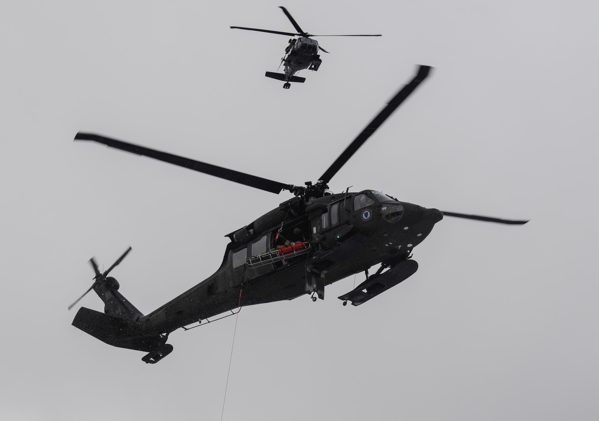 Alaska Army National Guard UH-60 Black Hawk helicopters arrive on scene during a mass-casualty search-and-rescue training at Joint Base Elmendorf-Richardson, Alaska, Nov. 21, 2017. During the exercise, the rescue operators located, assessed, treated and evacuated numerous casualties while engaging and eliminating multiple attacks from opposition forces. In addition to training for combat search-and-rescue missions, the 212th Rescue Squadron also provides emergency rescue services for Alaska residents and visitors. (U.S. Air Force photo by Senior Airman Curt Beach)
