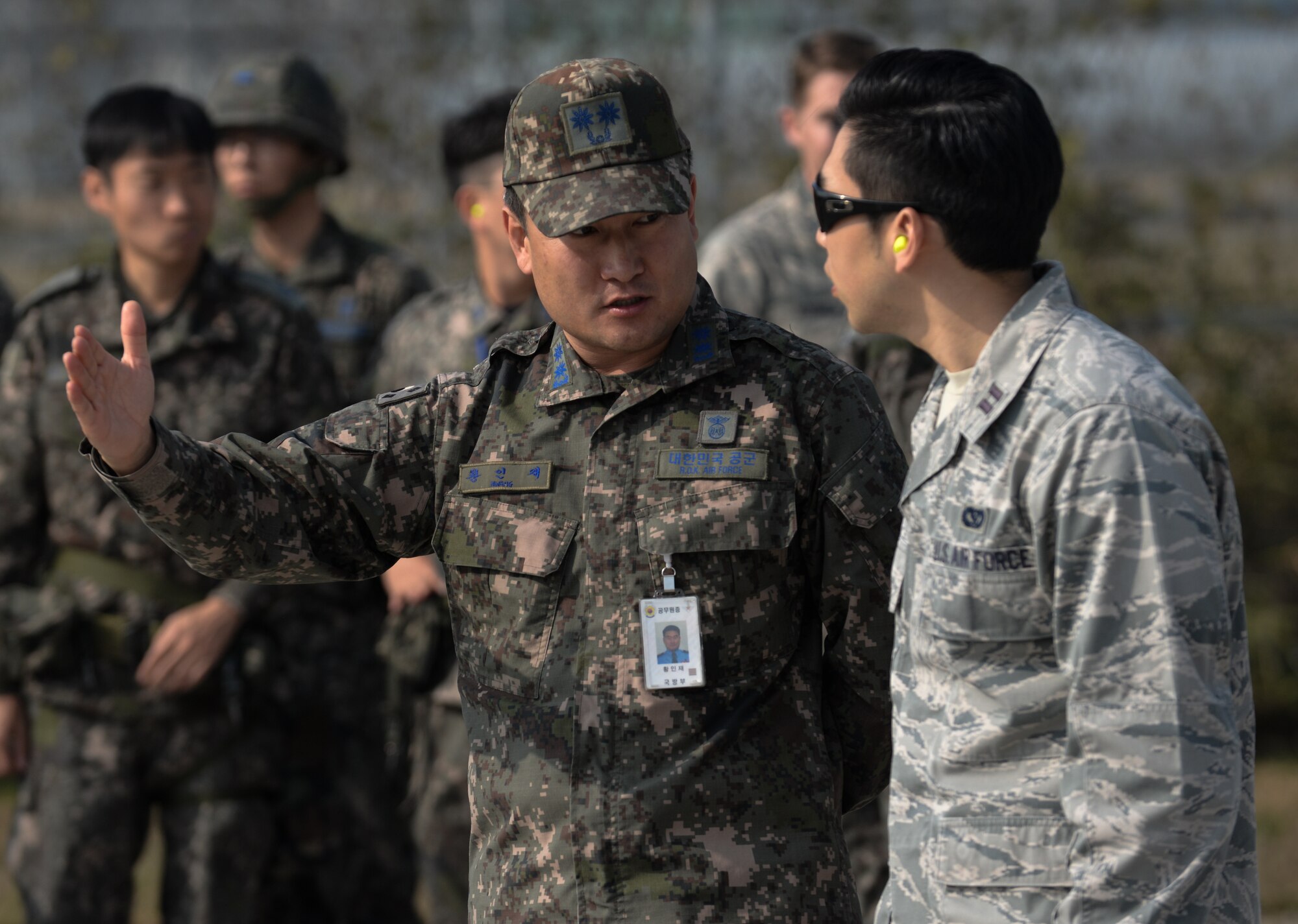 Republic of Korea Air Force Lt. Col. Injae Hwang, Air Force Operation and Command, speaks with U.S. Air Force Capt. Christopher Paek, 7th Air Force during a Rapid Airfield Damage Repair bilateral training exercise at Gwangju Air Base, R.O.K., Nov. 8, 2017. U.S. and R.O.K. Airmen trained together for a week to learn the new RADR process, preparing them for response to wartime contingencies, enhancing interoperability and building partnership capacity in the Indo-Asia Pacific region. (U.S. Air Force photo by Senior Airman Curt Beach)
