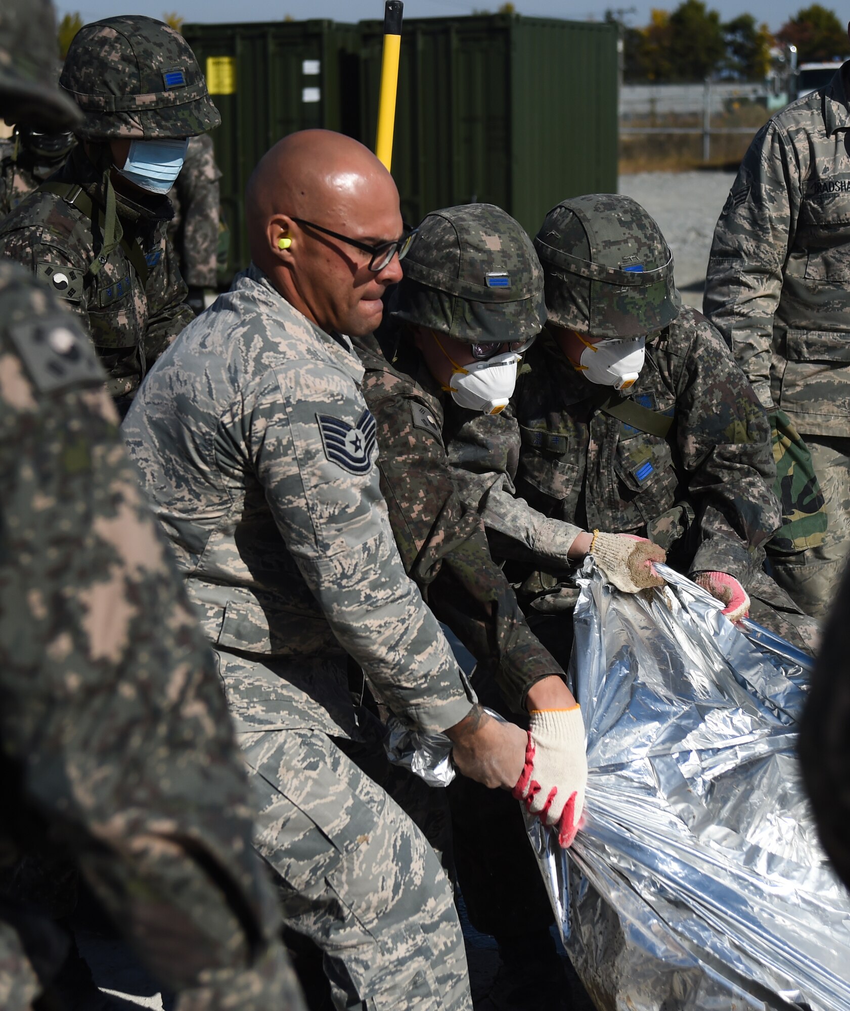 U.S. Air Force and Republic of Korea Airmen empty concrete into a crater during a Rapid Airfield Damage Repair bilateral training exercise at Gwangju Air Base, R.O.K., Nov. 9, 2017. U.S. and R.O.K. Airmen trained together for a week to learn the new RADR process, preparing them for response to wartime contingencies, enhancing interoperability and building partnership capacity in the Indo-Asia Pacific region. (U.S. Air Force photo by Senior Airman Curt Beach)
