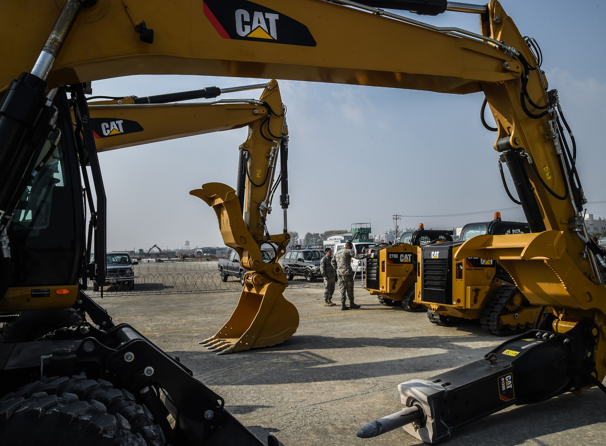 U.S. Air Force Airmen examine heavy machinery during a Rapid Airfield Damage Repair bilateral training exercise at Gwangju Air Base, Republic of Korea, Nov. 8, 2017. U.S. and R.O.K. Airmen trained together for a week to learn the new RADR process, preparing them for response to wartime contingencies, enhancing interoperability and building partnership capacity in the Indo-Asia Pacific region. The new process makes use of rapid-setting concrete which enables vehicles to pass over it after one hour and any aircraft within two hours. (U.S. Air Force photo by Senior Airman Curt Beach)