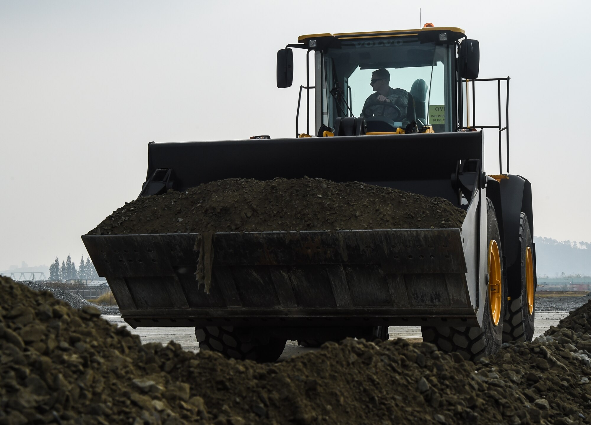 U.S. Air Force Senior Airman Ryan Boggess, 773d Civil Engineer Squadron, operates a front-end loader during a Rapid Airfield Damage Repair training exercise at Gwangju Air Base, Republic of Korea., Nov. 8, 2017. Approximately forty U.S. Airmen from the 773d Civil Engineer Squadron at Joint Base Elmendorf-Richardson, Alaska, and 40 Republic of Korea Airmen from Gwangju trained together for a week to learn a new runway repair process for wartime contingencies. The bilateral training exercise enhanced interoperability and strengthen partnerships in the Indo-Asia Pacific region. (U.S. Air Force photo by Senior Airman Curt Beach)